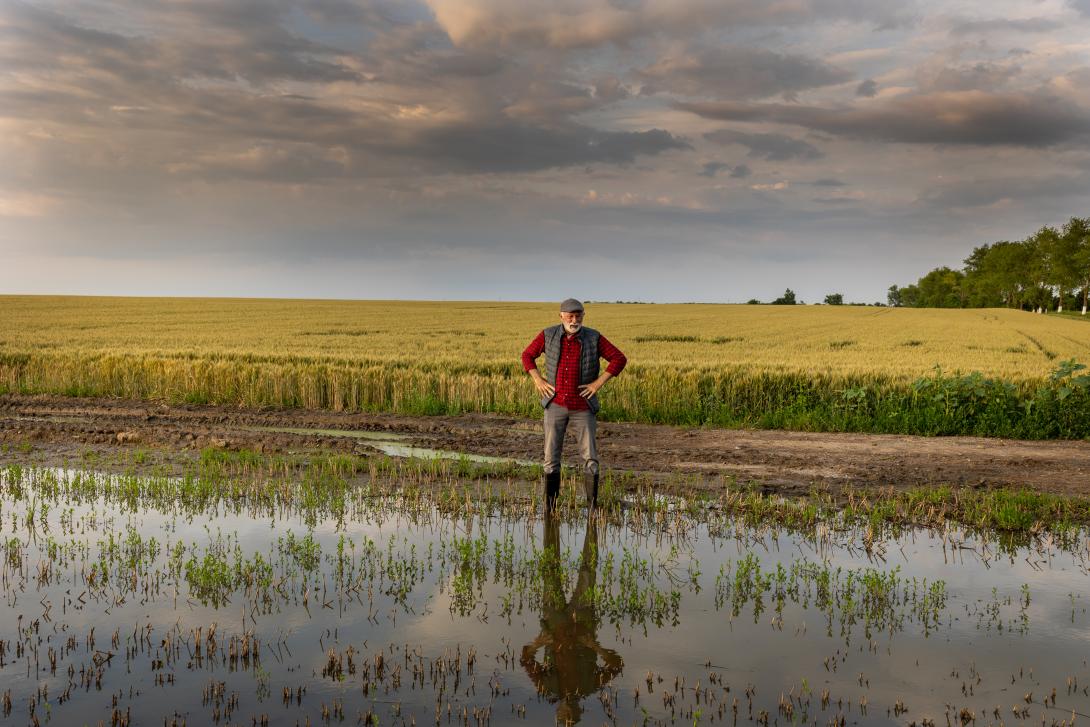 Landwirt am Feld nach Starkregenereignis